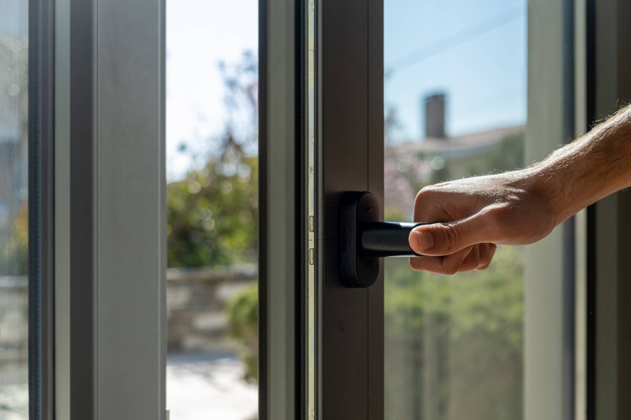 Someone opening a metal door with windows at Blind Scapes near Albuquerque, New Mexico (NM)